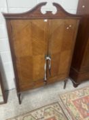 Reproduction mahogany veneered two door cupboard with arched pediment