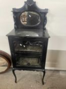 A late Victorian ebonised music cabinet with mirrored back