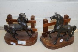 A pair of horse formed metal and wood bookends