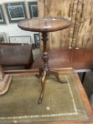 A reproduction tripod base wine table