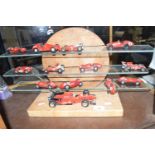 A wooden display stand and various model Ferrari's