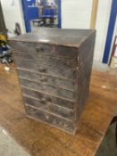 A stained pine eight drawer table top chest, 28cm wide