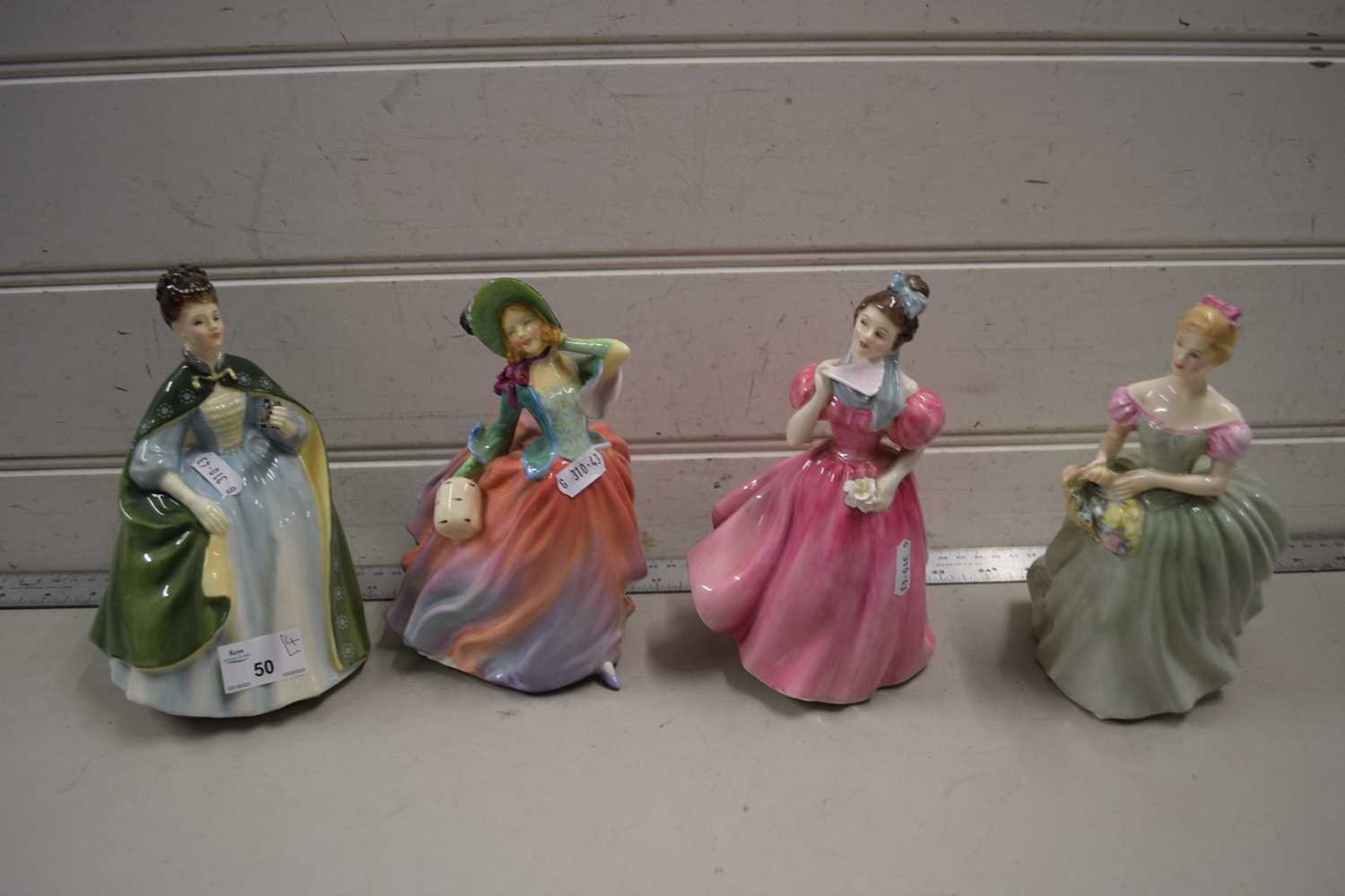 A collection of four Royal Doulton figurines