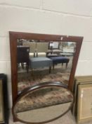 An oval bevelled wall mirror in a mahogany frame together with a further rectangular wall mirror (