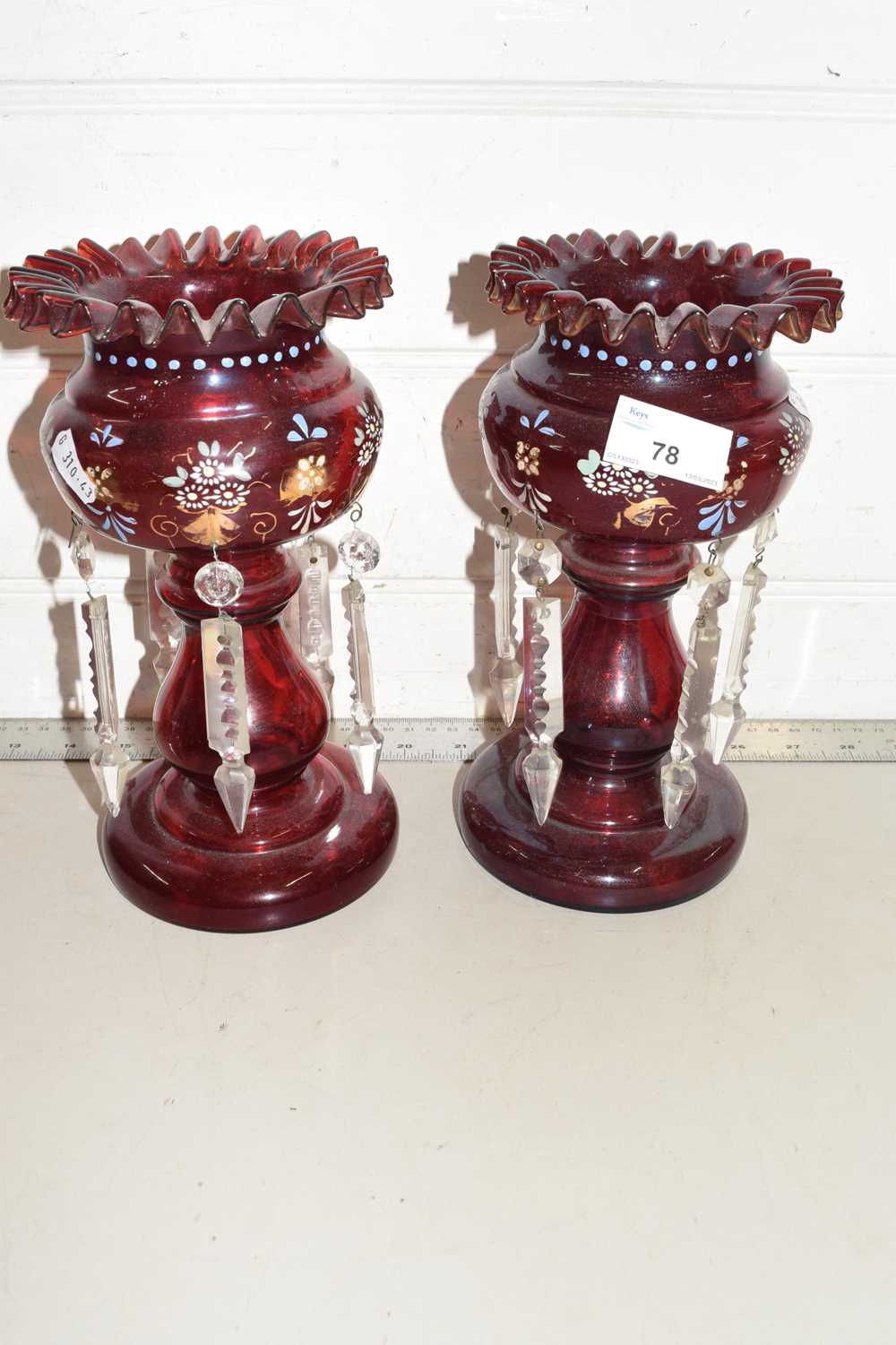 A pair of ruby glass table lustres with prismatic drapes, 23cm high