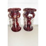 A pair of ruby glass table lustres with prismatic drapes, 23cm high