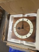 Modern wall clock with cream dial with black Roman numerals on faux wood effect backing, boxed