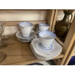 A quantity of early 20th Century tea wares in blue and white with chrome trim