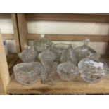 A quantity of mixed cut and pressed glass dressing table pots and containers