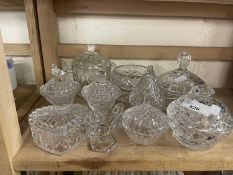 A quantity of mixed cut and pressed glass dressing table pots and containers