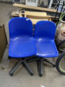 Two blue plastic desk chairs