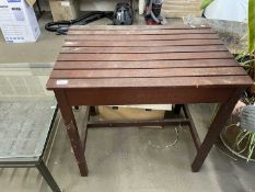 A hardwood slatted top table