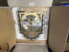 A Kieninger wall clock with brushed brass and chrome effect dials, Roman numerals, black hands and