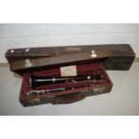 Cased clarinet marked J R Lafleur, London and Paris together with a further carved wooden instrument