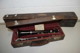 Cased clarinet marked J R Lafleur, London and Paris together with a further carved wooden instrument