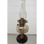 A vintage oil lamp with glass font