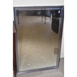 A metal framed bevelled wall mirror