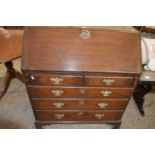 18th Century oak bureau with full front and fitted interior over a base with two short and three