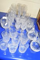 A collection of various cut glass drinking glasses