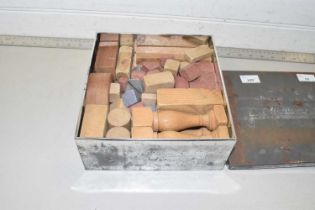 A set of vintage wooden and stone architectural building blocks, columns and pieces.