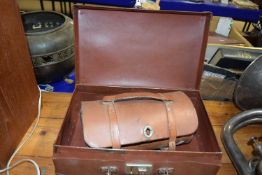Two wooden lawn bowls together with leather case and a further small case