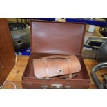 Two wooden lawn bowls together with leather case and a further small case