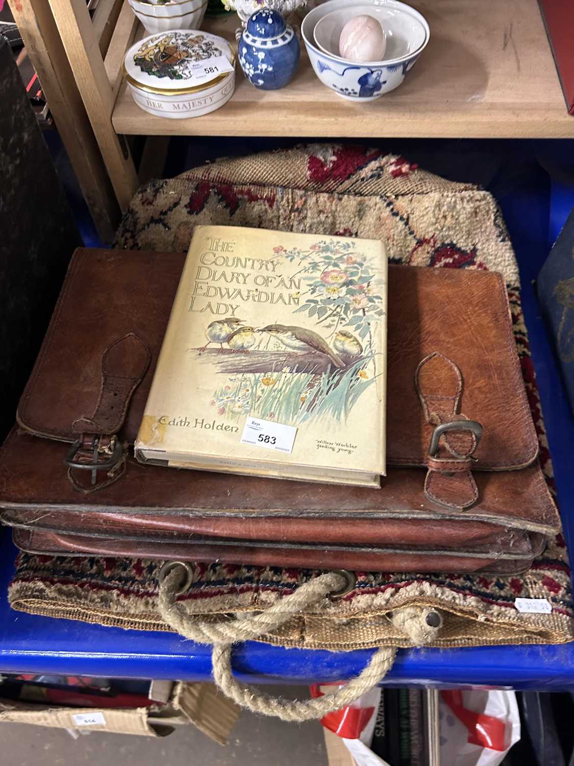 A carpet bag, a leather satchell and a copy of The Country Diary of an Edwardian Lady