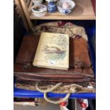 A carpet bag, a leather satchell and a copy of The Country Diary of an Edwardian Lady