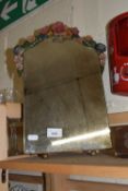 A freestanding dressing table mirror with resin moulded floral decoration