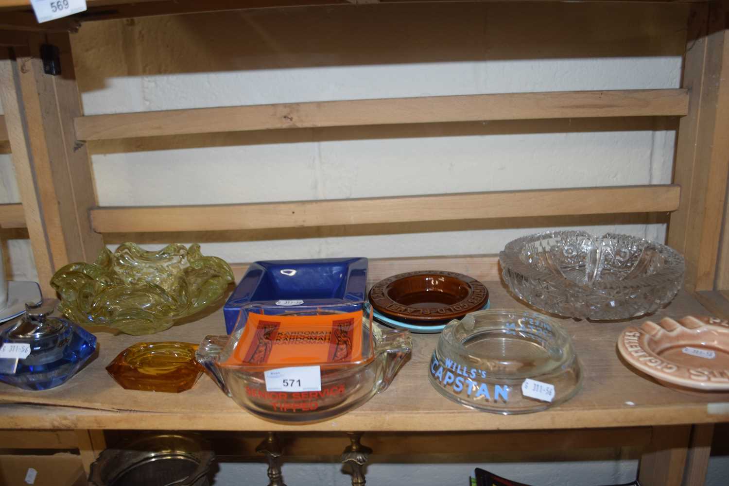 A blue glass table lighter together with a quantity of ashtrays