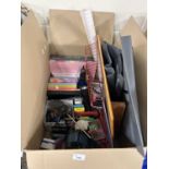 One box of various photograph albums, highlighter pens, binoculars, and other assorted house