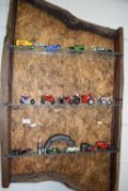 Rustic wall shelf with a quantity of model cars and motorbikes