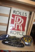 A Rolls Royce sign together with an AA badge and other motoring items