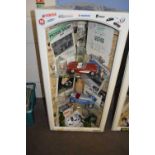 Motoring interest - a corner cabinet decorated with motoring ephemera together with shelf contents