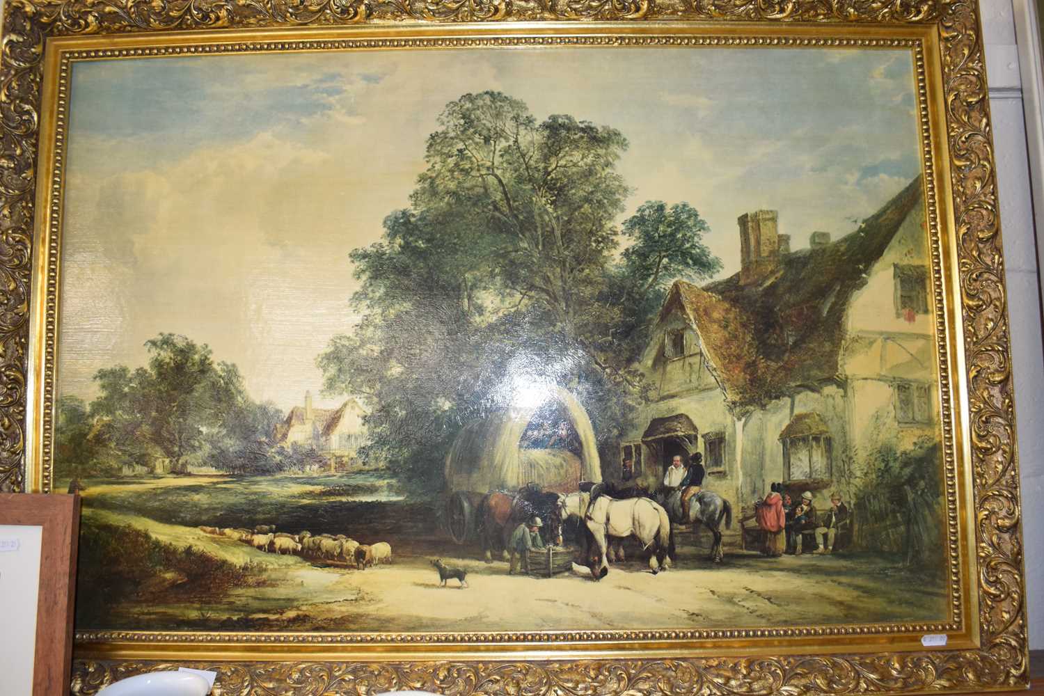 A reproduction print of country scene by a tavern in gilt moulded frame