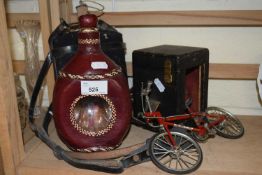 A leather cased carriage clock holder together with a leather clad bottle, wine flask and model
