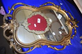 A gilt framed wall mirror together with a moulded gilt brass picture frame