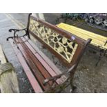 Iron and wood garden bench with rose decorated back and slatted seat, 125cm wide