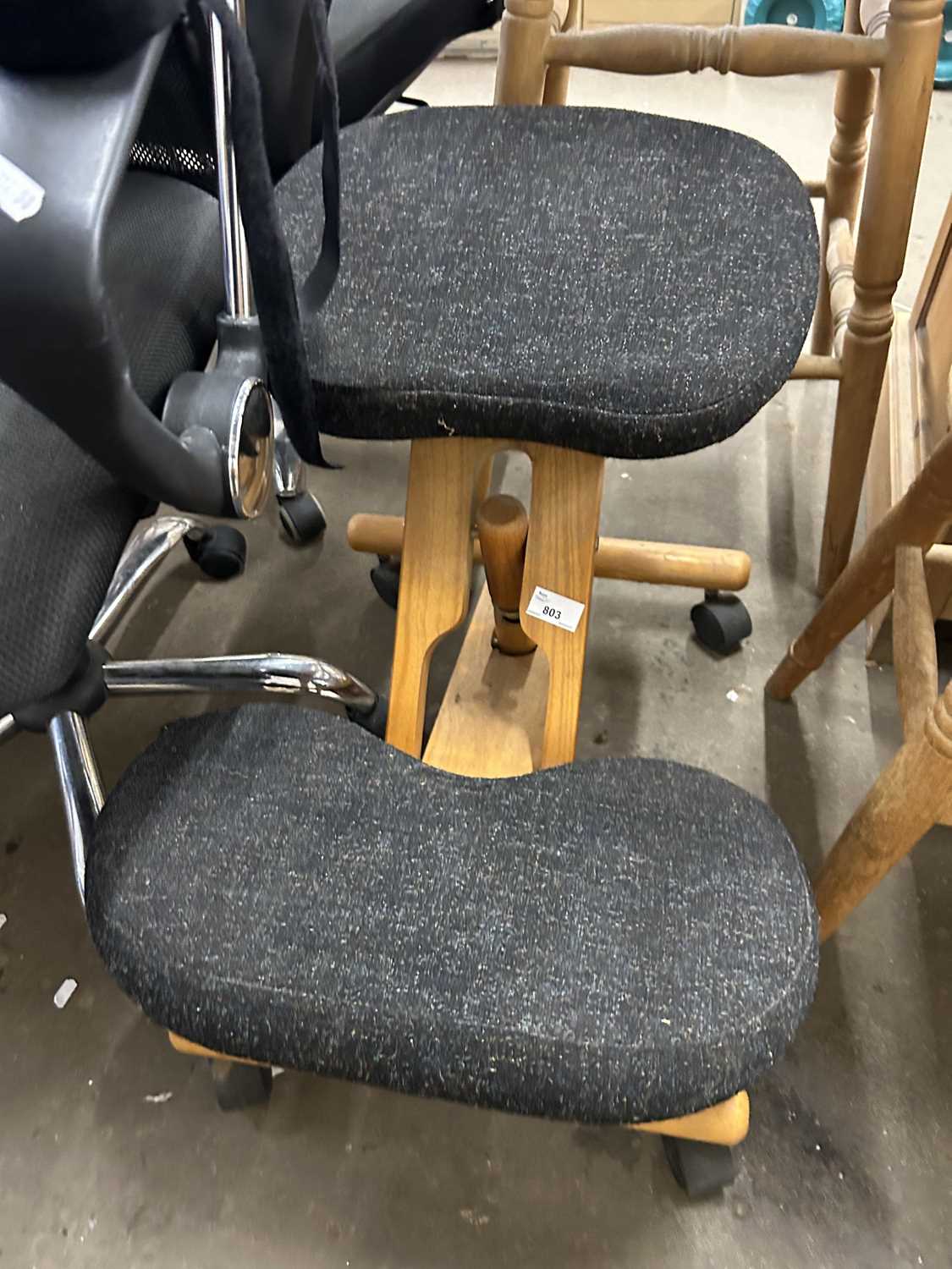 An upholstered kneeler on casters