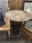 A pine side table with pie crust top and barley twist legs
