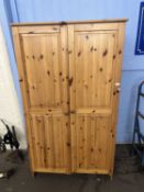 A two door pine wardrobe, 100cm wide