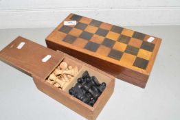 Turned wooden chess set and accompanying folding chess board