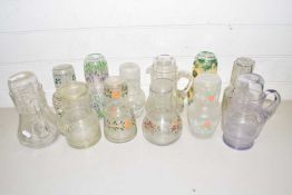 Collection of various floral decorated carafes with glasses plus further jugs and similar items