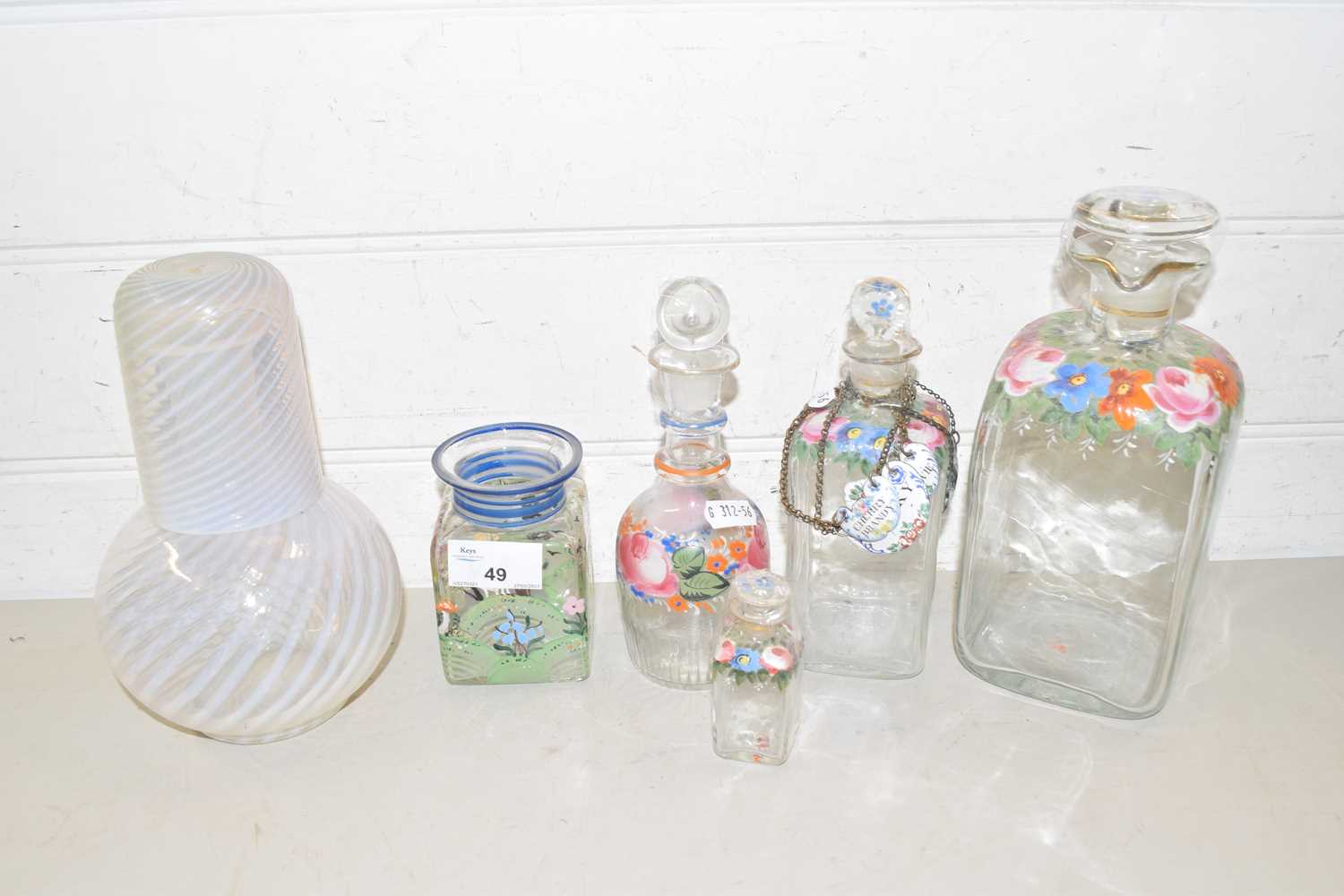 Mixed Lot: Vaseline glass decanter with cover together with further floral decorated decanters and