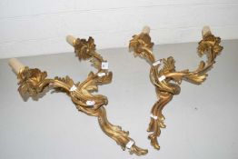 A pair of brass foliate formed twin light wall sconces