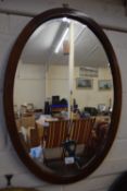 Edwardian oval bevelled wall mirror in mahogany frame
