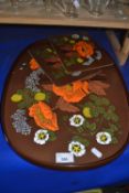 A mid 20th Century brown and orange floral decorated tea tray together with two table mats