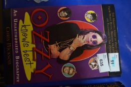 A paperback copy of Ozzy Knows Best: An Unauthorized biography of Ozzy Osbourne, front man of