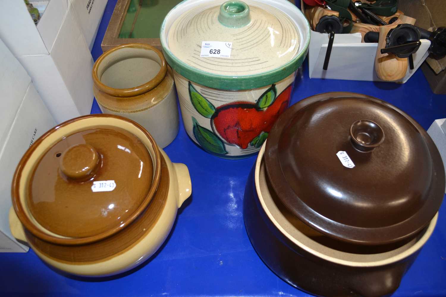 Two pottery dishes and covers, a biscuit barrel and cover and a stone ware pot