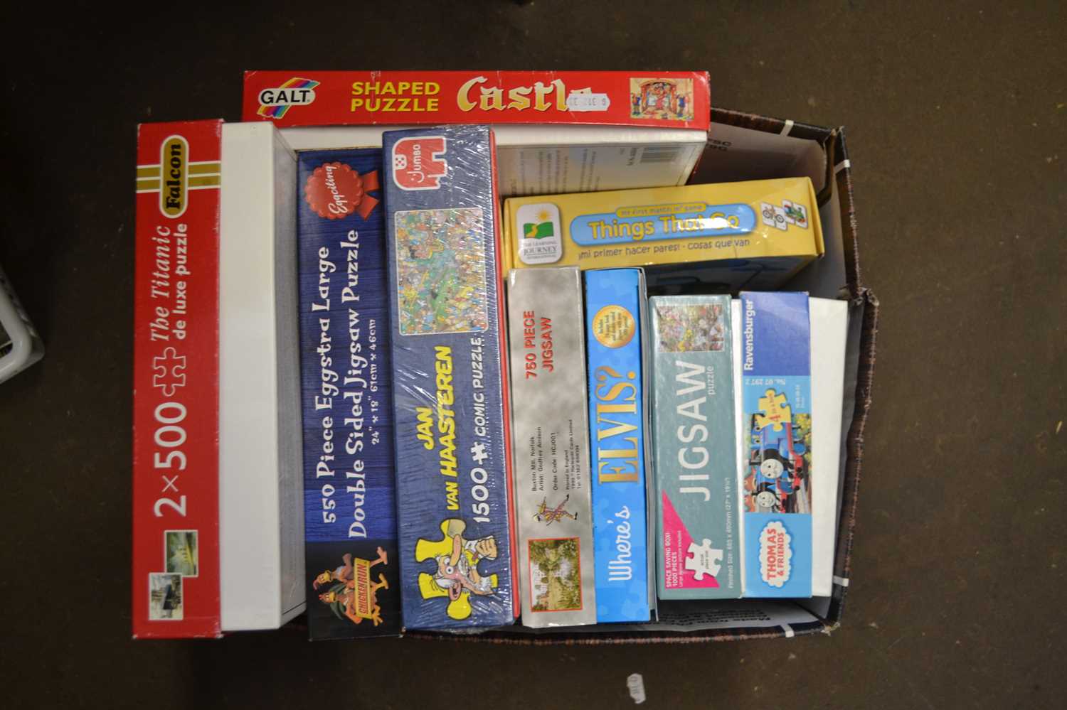 Box of assorted jigsaw puzzles